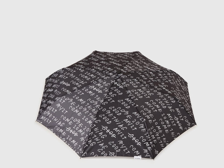 black umbrella with coco capitán text